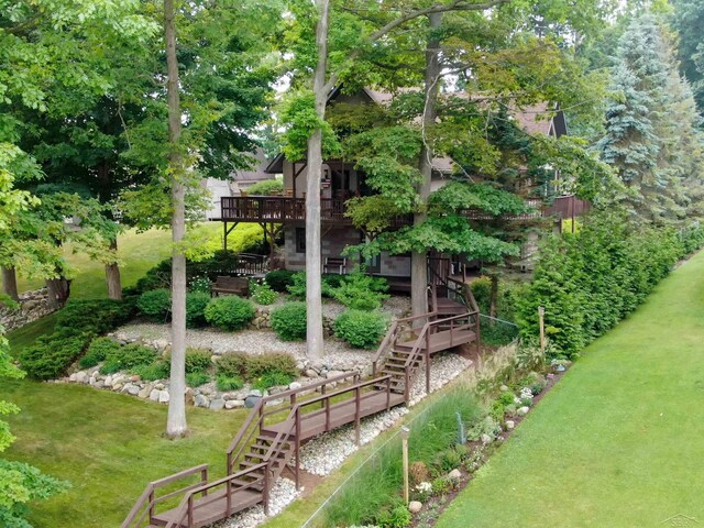5370 N Lake Sanford Rd, Sanford, MI 48657 - view of green lawn with stairway and a deck