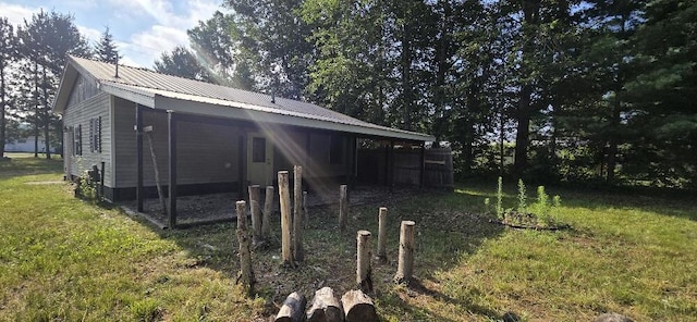 4997 S Croton Hardy Dr, Newaygo, MI 49337 - view of side of property featuring a yard and a metal roof