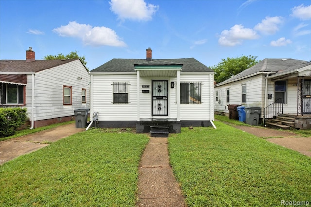 3887 Moore Ave, Allen Park, MI 48141 - bungalow with a front lawn, a shingled roof, and a chimney