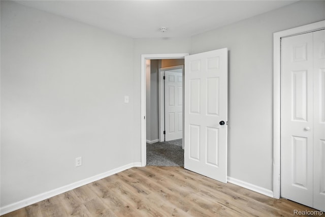3887 Moore Ave, Allen Park, MI 48141 - unfurnished bedroom featuring light wood-style flooring and a closet