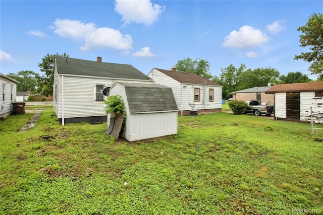 3887 Moore Ave, Allen Park, MI 48141 - back of house with a storage shed, a chimney, a yard, and a shingled roof