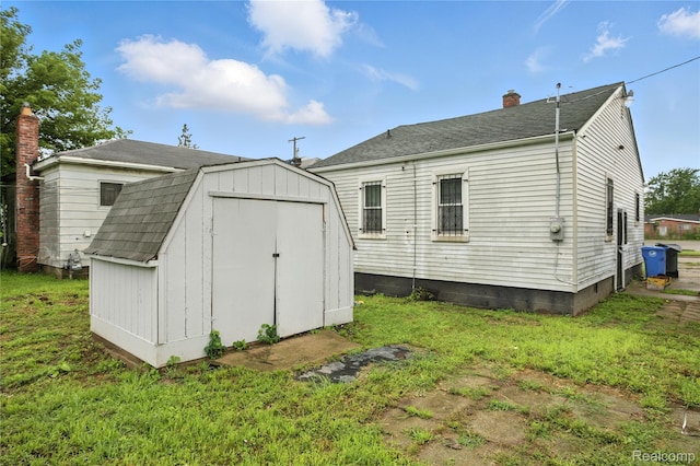3887 Moore Ave, Allen Park, MI 48141 - back of house featuring a storage unit, a chimney, and a yard