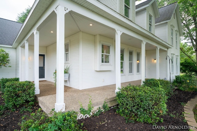 401 Erin Isle Ct, Holland, MI 49424 - view of side of property with covered porch and roof with shingles