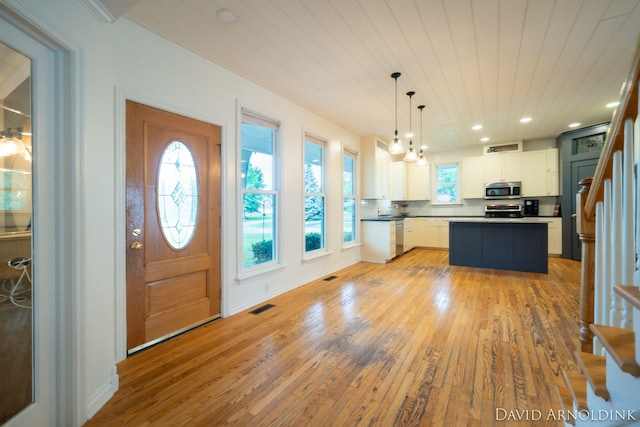 401 Erin Isle Ct, Holland, MI 49424 - foyer entrance with light wood-type flooring, stairs, and recessed lighting