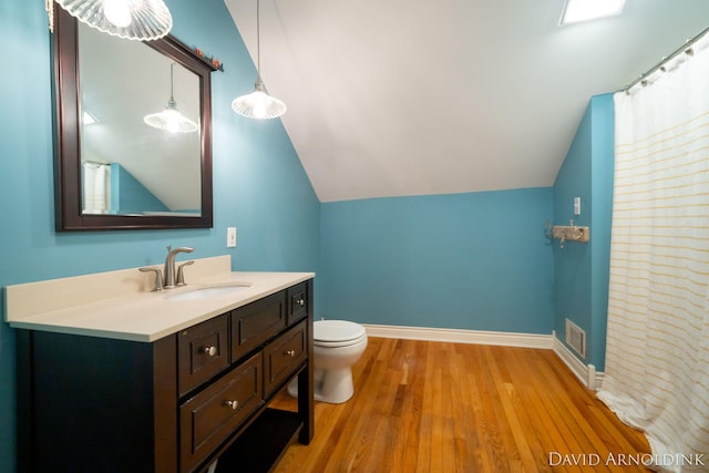 401 Erin Isle Ct, Holland, MI 49424 - bathroom with vanity, wood finished floors, and vaulted ceiling