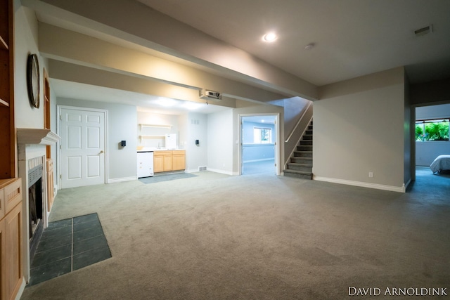 401 Erin Isle Ct, Holland, MI 49424 - unfurnished living room featuring carpet floors, stairs, a tile fireplace, and recessed lighting