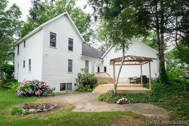 401 Erin Isle Ct, Holland, MI 49424 - back of property featuring a gazebo, a deck, a patio, and a chimney