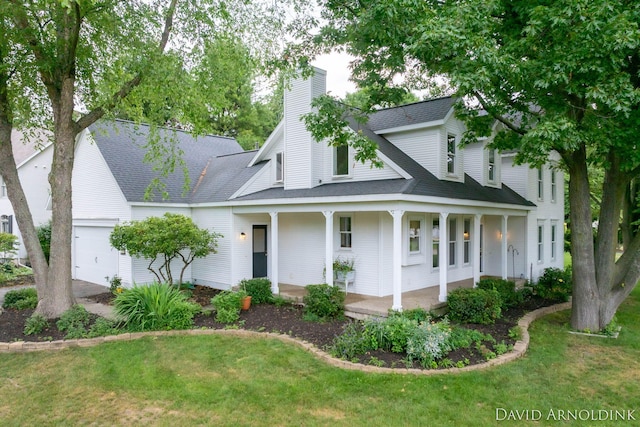 401 Erin Isle Ct, Holland, MI 49424 - view of front facade with a porch, an attached garage, a chimney, and a front lawn