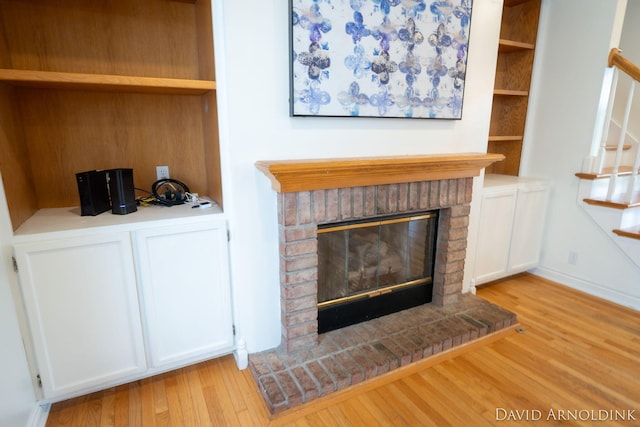 401 Erin Isle Ct, Holland, MI 49424 - detailed view of wood finished floors and a brick fireplace