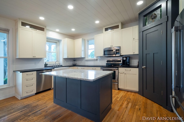 401 Erin Isle Ct, Holland, MI 49424 - kitchen featuring stainless steel appliances, backsplash, wood finished floors, recessed lighting, and white cabinets