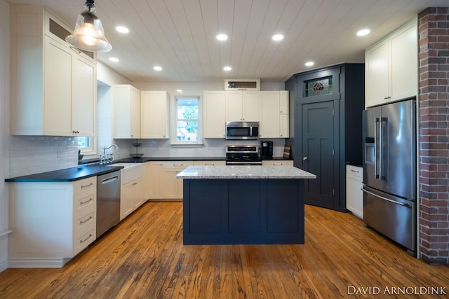 401 Erin Isle Ct, Holland, MI 49424 - kitchen featuring appliances with stainless steel finishes, dark wood-type flooring, a kitchen island, recessed lighting, and wood ceiling