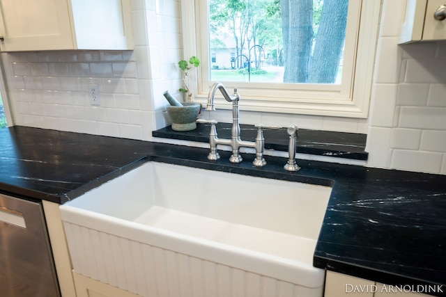 401 Erin Isle Ct, Holland, MI 49424 - kitchen with tasteful backsplash, white cabinets, stainless steel dishwasher, and dark countertops