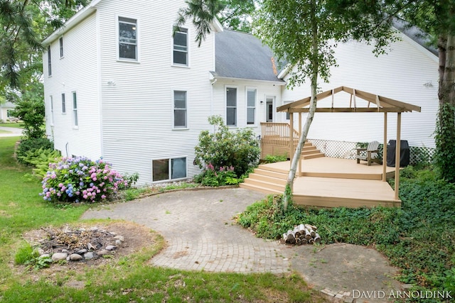 401 Erin Isle Ct, Holland, MI 49424 - back of property with a gazebo, a deck, an outdoor fire pit, roof with shingles, and a patio
