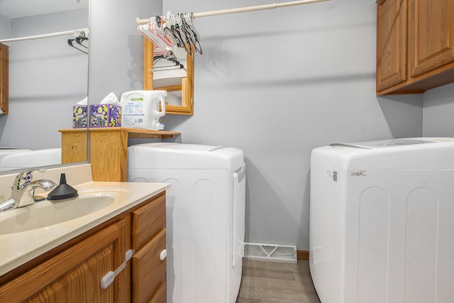 10850 Rajah Dr, Zeeland, MI 49464 - washroom with washer and clothes dryer and cabinet space