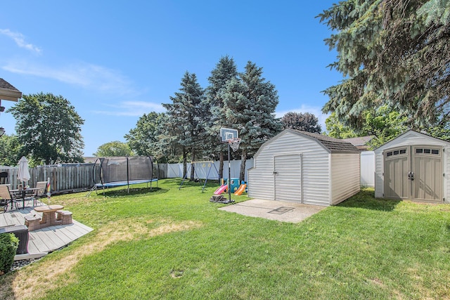 10850 Rajah Dr, Zeeland, MI 49464 - fenced backyard with a storage shed, a trampoline, a wooden deck, and a playground