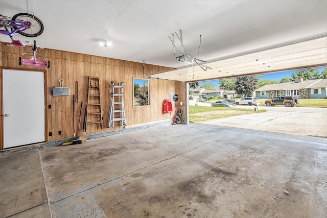 10850 Rajah Dr, Zeeland, MI 49464 - garage with wooden walls and a garage door opener