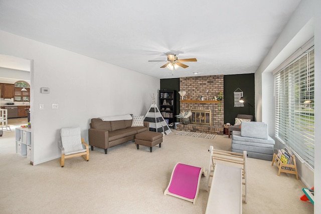 10850 Rajah Dr, Zeeland, MI 49464 - living area with light colored carpet, ceiling fan, and a fireplace