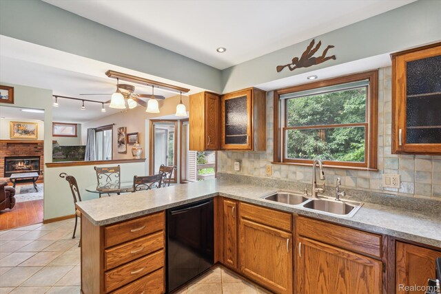 7740 Athlone Dr, Brighton, MI 48116 - kitchen featuring dishwasher, brown cabinets, and decorative backsplash