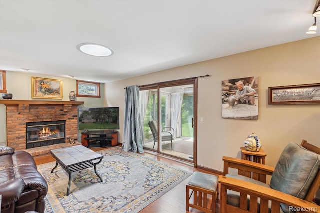 7740 Athlone Dr, Brighton, MI 48116 - living room with wood finished floors and a brick fireplace