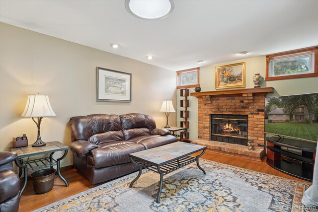 7740 Athlone Dr, Brighton, MI 48116 - living room featuring wood finished floors and a fireplace