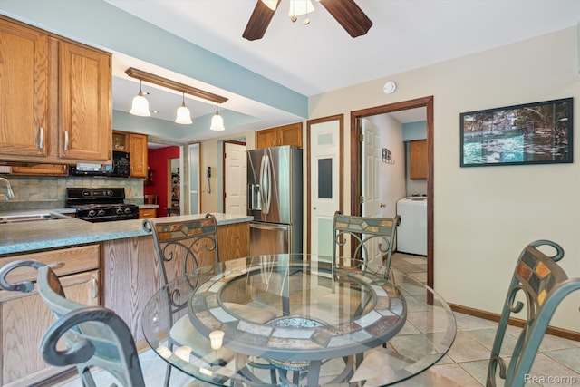 7740 Athlone Dr, Brighton, MI 48116 - dining area with a ceiling fan, washer / clothes dryer, and light tile patterned floors