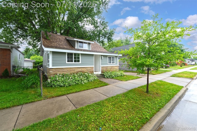 313 W Harwood Ave, Madison Heights, MI 48071 - bungalow-style home with stone siding and a shingled roof