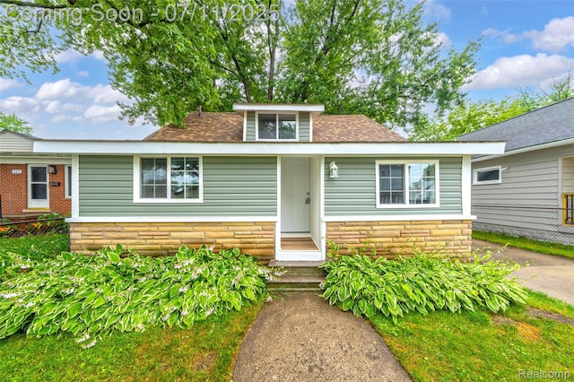 313 W Harwood Ave, Madison Heights, MI 48071 - view of front of home with stone siding and a shingled roof