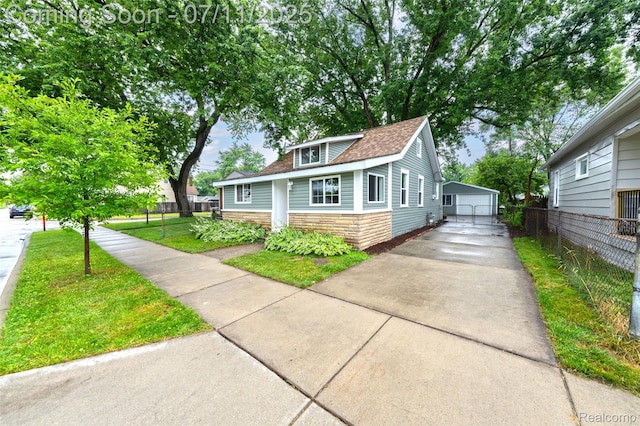 313 W Harwood Ave, Madison Heights, MI 48071 - bungalow-style home featuring stone siding, a shingled roof, an outdoor structure, and a garage