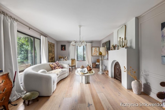 1217 El Camino Dr NW, Grand Rapids, MI 49504 - living room featuring a chandelier, light wood-type flooring, healthy amount of natural light, and a fireplace