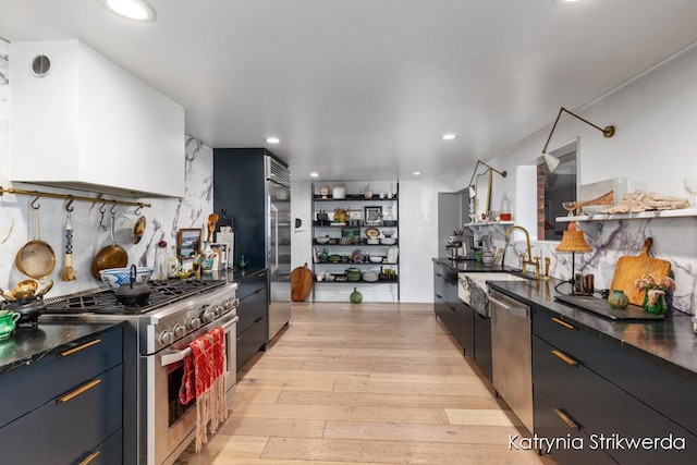 1217 El Camino Dr NW, Grand Rapids, MI 49504 - kitchen featuring stainless steel appliances, dark countertops, backsplash, and recessed lighting