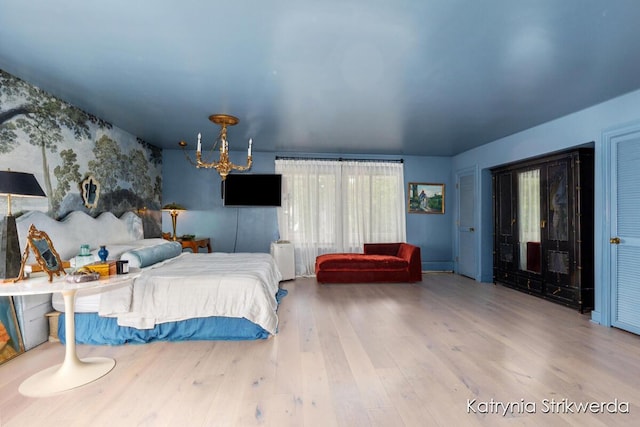 1217 El Camino Dr NW, Grand Rapids, MI 49504 - bedroom featuring a chandelier and wood finished floors