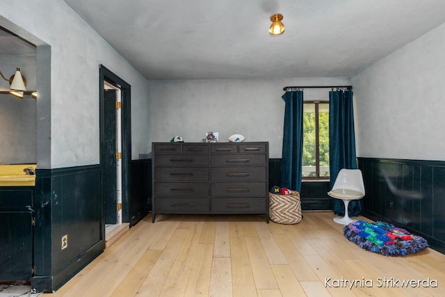 1217 El Camino Dr NW, Grand Rapids, MI 49504 - bedroom featuring a wainscoted wall and hardwood / wood-style floors