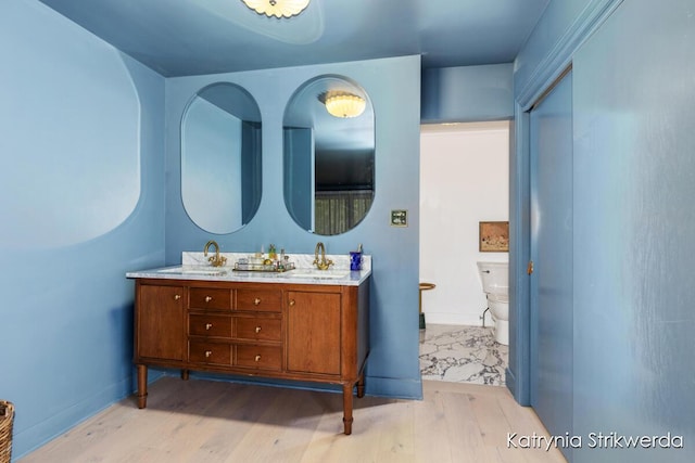 1217 El Camino Dr NW, Grand Rapids, MI 49504 - bathroom featuring wood finished floors and double vanity