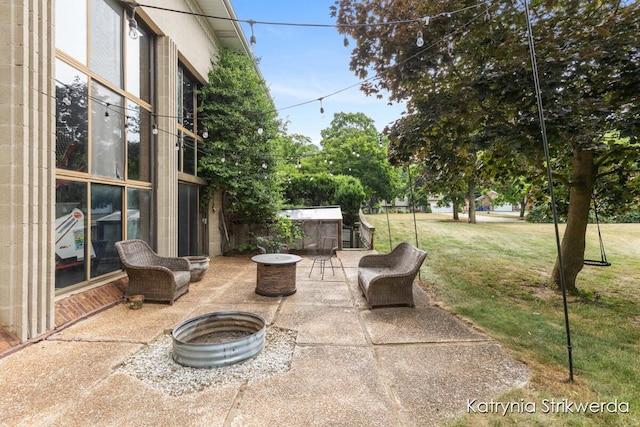 1217 El Camino Dr NW, Grand Rapids, MI 49504 - view of patio with a fire pit and a hot tub