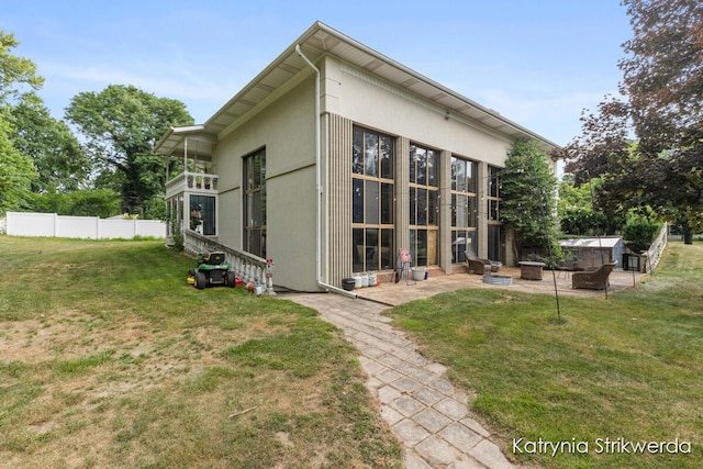 1217 El Camino Dr NW, Grand Rapids, MI 49504 - rear view of property with a patio and stucco siding