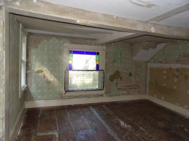 209 E High St, Union City, MI 49094 - spare room with wood-type flooring and baseboards