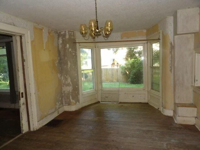 209 E High St, Union City, MI 49094 - unfurnished dining area with a chandelier, healthy amount of natural light, and wood finished floors
