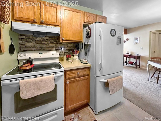 7382 Central St Unit 4, Westland, MI 48185 - kitchen with white appliances, under cabinet range hood, tasteful backsplash, light countertops, and light carpet