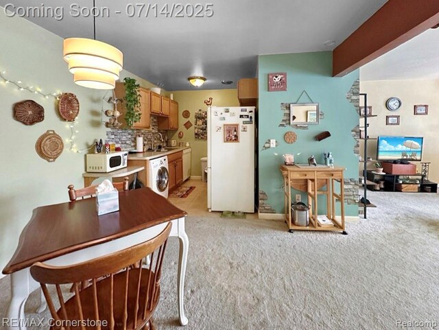 7382 Central St Unit 4, Westland, MI 48185 - kitchen with white appliances, washer / clothes dryer, light countertops, light carpet, and backsplash