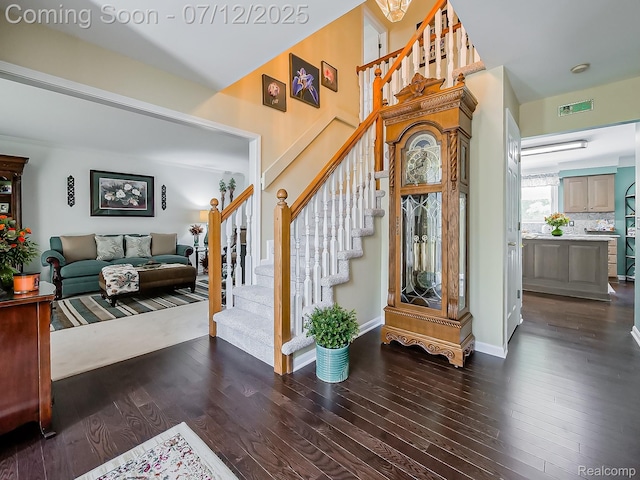 12495 Howland Park Dr, Plymouth, MI 48170 - entrance foyer with stairway, dark wood-type flooring, and a towering ceiling