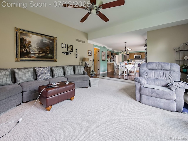 12495 Howland Park Dr, Plymouth, MI 48170 - living room featuring ceiling fan, carpet, and a chandelier