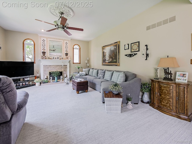 12495 Howland Park Dr, Plymouth, MI 48170 - living room with carpet flooring, a ceiling fan, and a fireplace with raised hearth