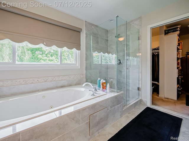 12495 Howland Park Dr, Plymouth, MI 48170 - bathroom with tile patterned flooring, a tub with jets, a stall shower, and a walk in closet
