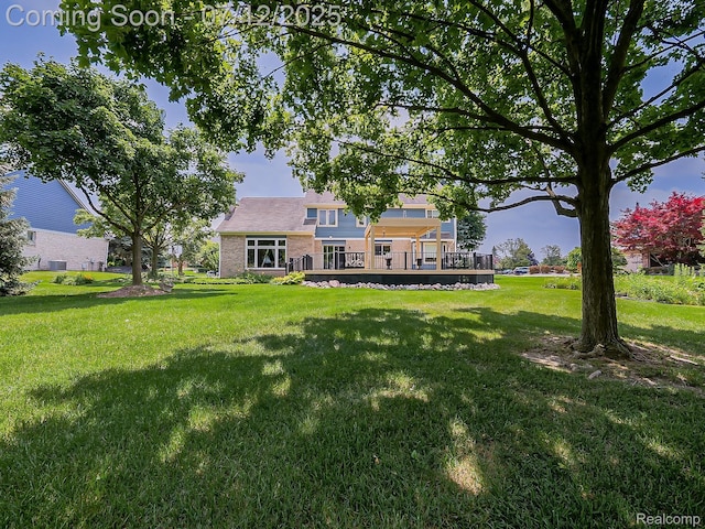 12495 Howland Park Dr, Plymouth, MI 48170 - view of green lawn with a wooden deck