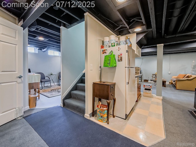 12495 Howland Park Dr, Plymouth, MI 48170 - below grade area featuring freestanding refrigerator and stairs