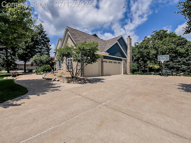 12495 Howland Park Dr, Plymouth, MI 48170 - view of side of property featuring driveway, brick siding, a chimney, and an attached garage