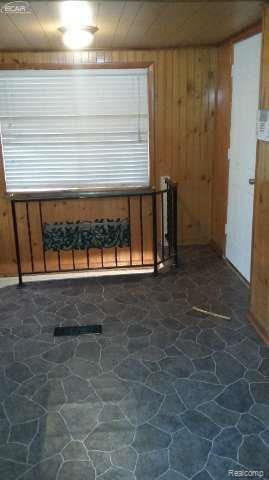 1702 Nebraska Ave, Flint, MI 48506 - interior space featuring stone flooring and wood walls