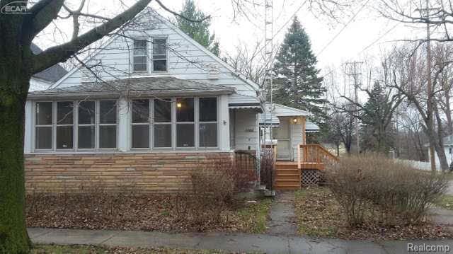 1702 Nebraska Ave, Flint, MI 48506 - view of front of house featuring a sunroom and stone siding