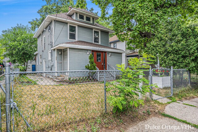 2025 Palace Ave SW, Grand Rapids, MI 49507 - american foursquare style home featuring a fenced front yard, a gate, and a shingled roof