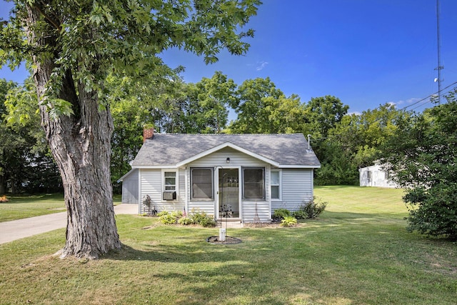 95 W N St, Ionia, MI 48846 - bungalow with a front yard, a chimney, a shingled roof, and cooling unit
